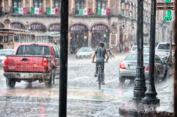 person riding a bicycle during rainy day